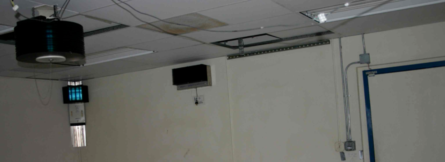 Photo of ultraviolet germicidal fixtures mounted in a room