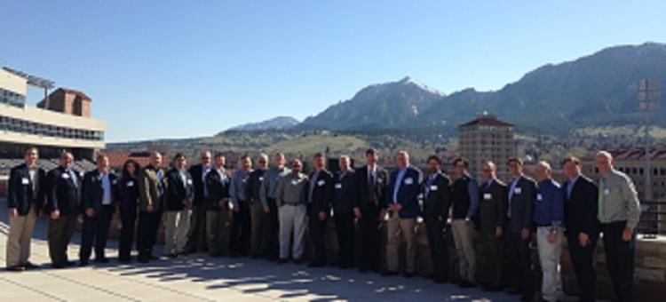 A group of well-dressed people standing on the roof of the Engineering Center