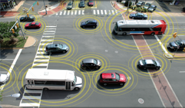 Cars and buses driving across an intersection