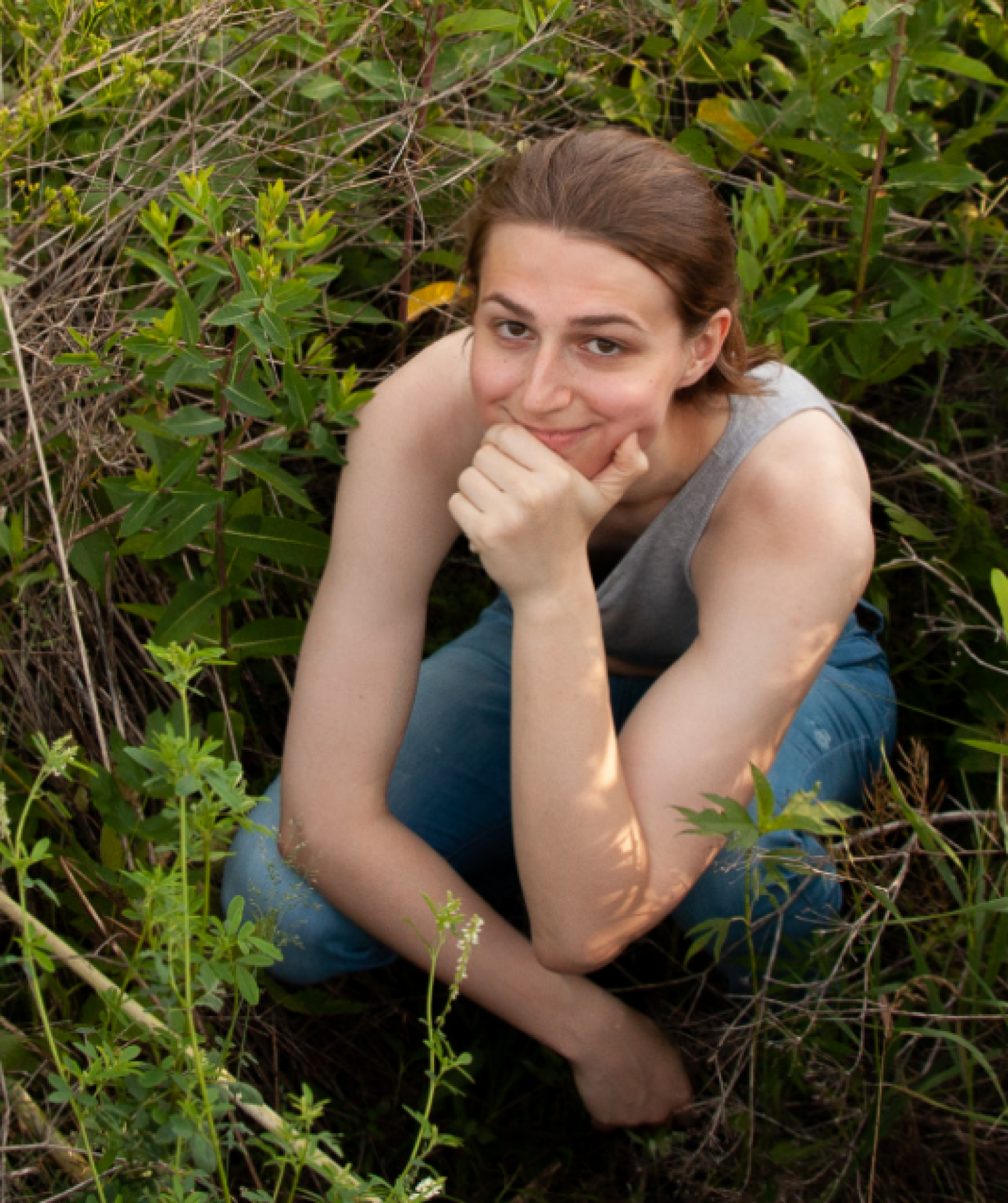 Allie sitting in a soybean field