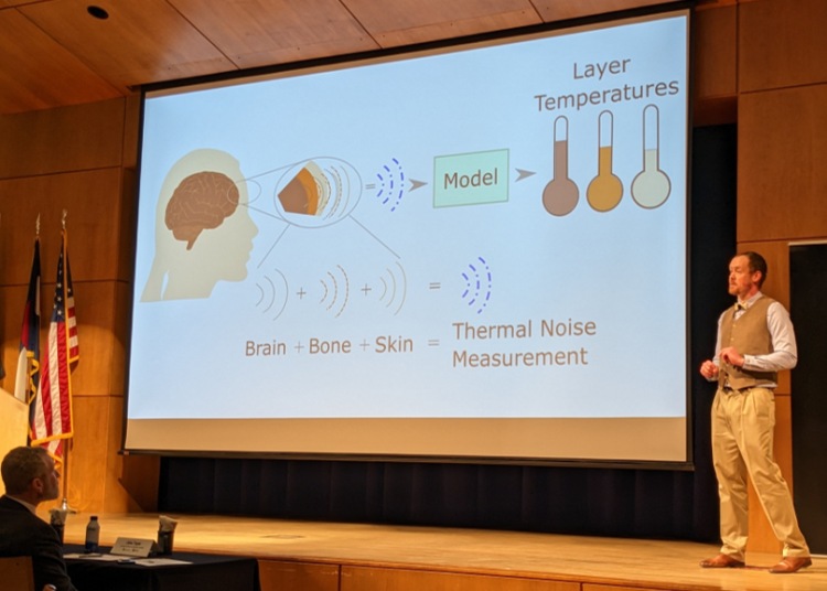 Rob Streeter presents "A New Way to Measure Internal Body Temperature" to Three Minute Thesis judges