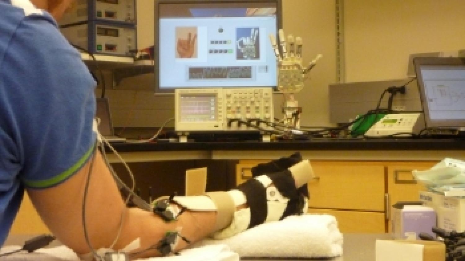 A person's arm being set up with a prosthetic hand.