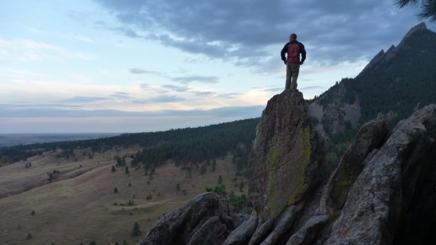 Jake stands on a rock with a good view of the front range.