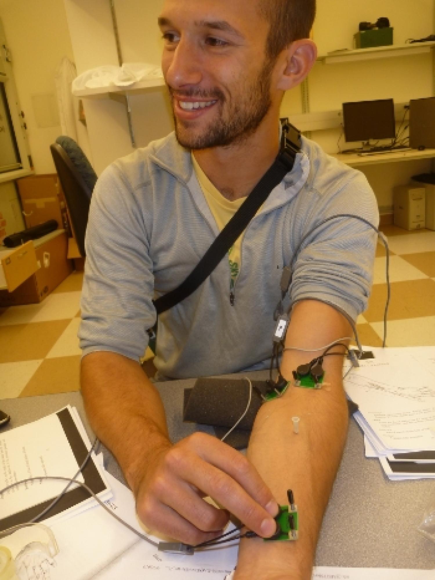 A man with three sensors attached to his arm.