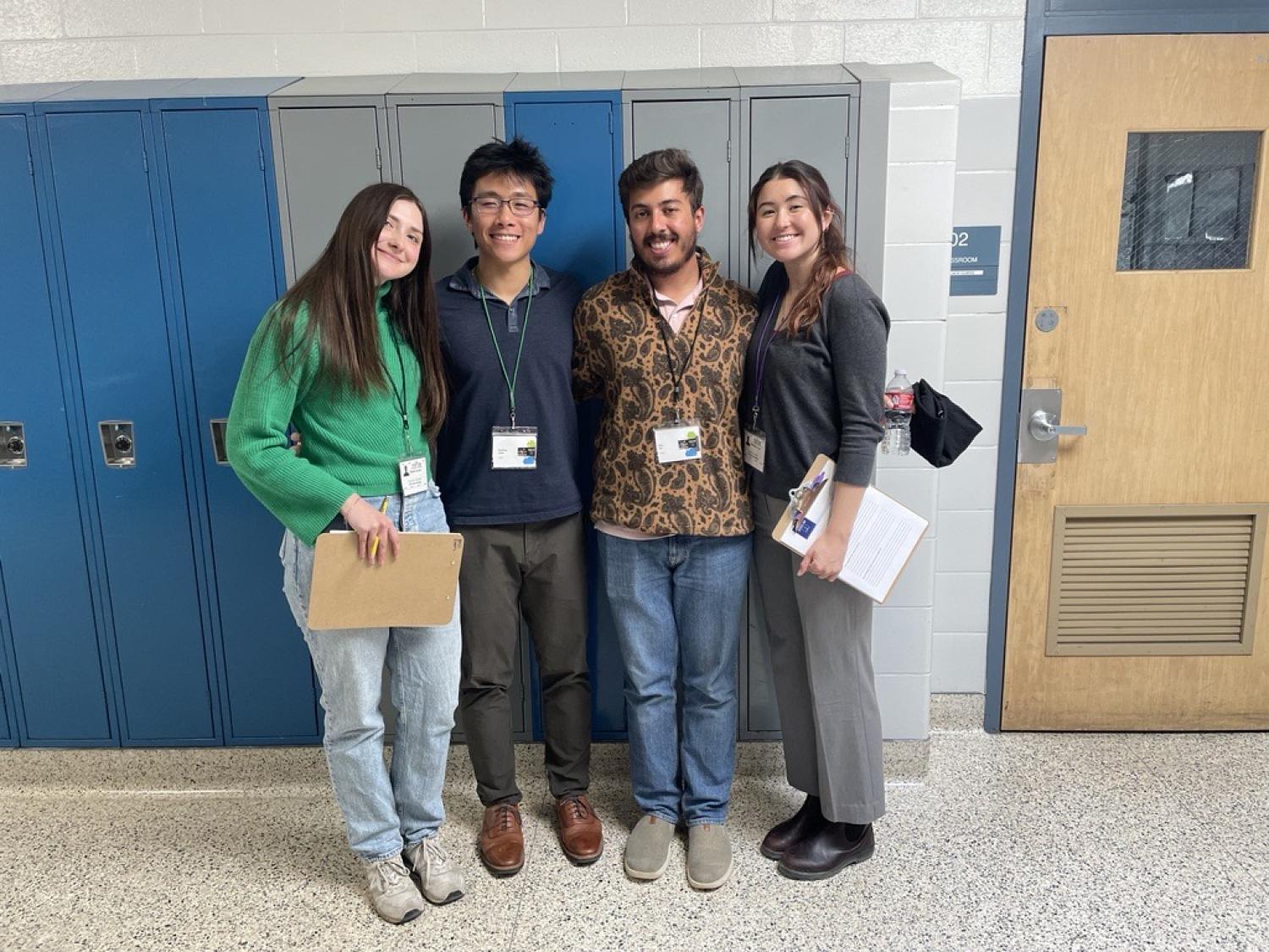 Abby, Matt, Ritu and Katie peer review science fair projects at a middle school. Matt was particularly harsh