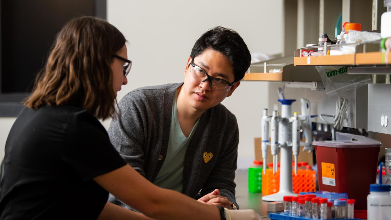 Two people talking in the lab