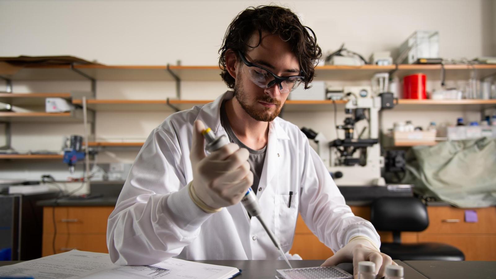 Person pipetting in the lab