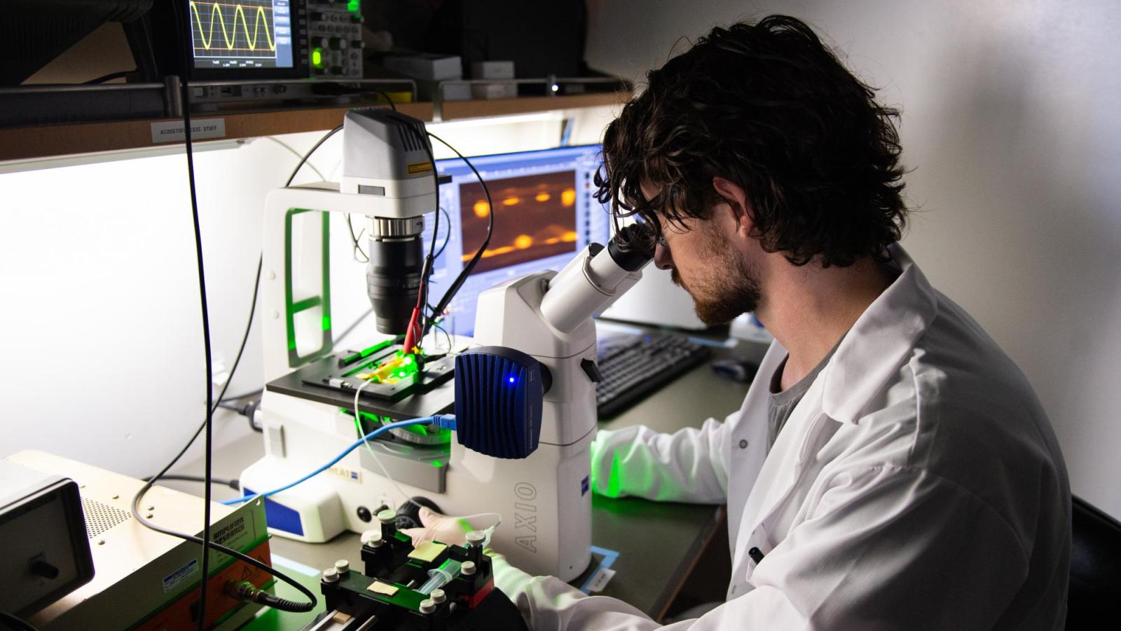 Image of person at microscope