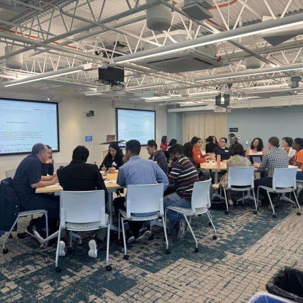 Faculty at tables discussing