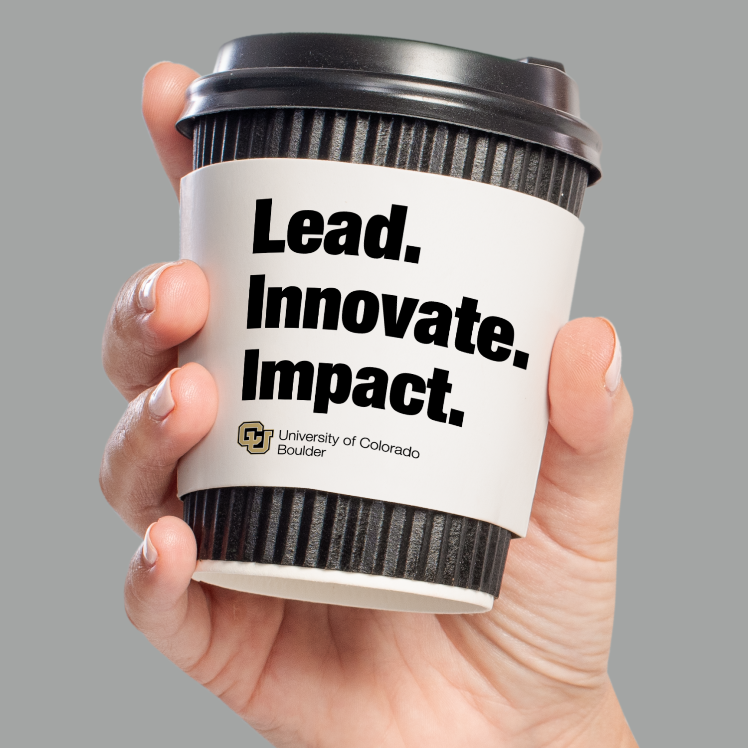 coffee cup with lead, innovate, impact written on it