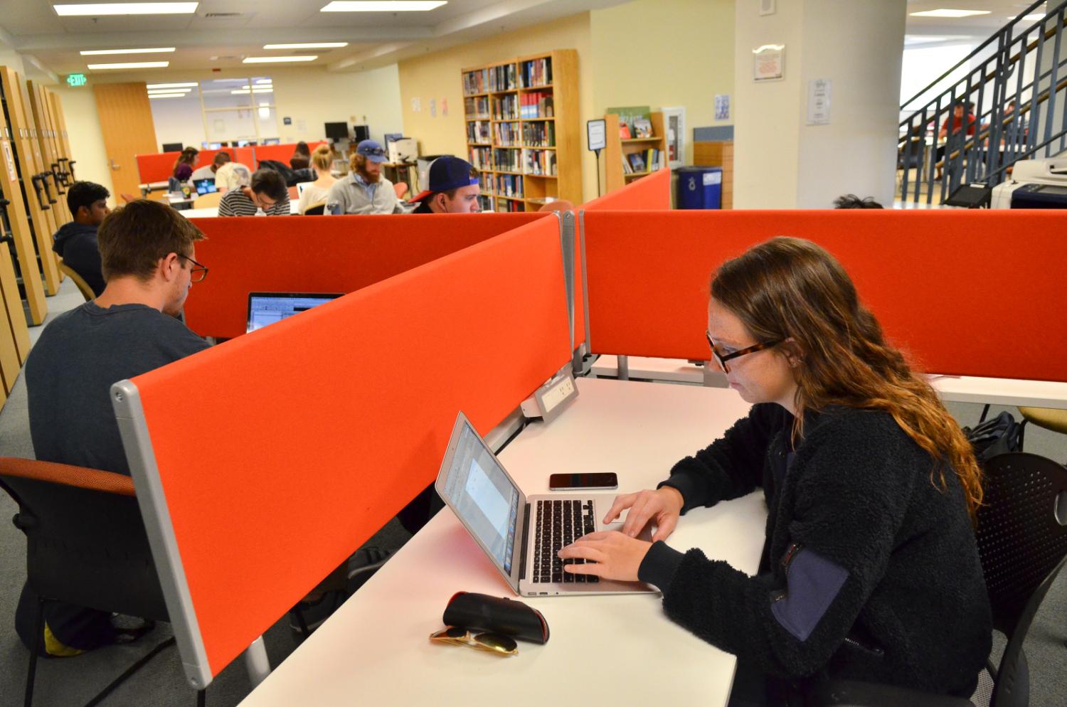 Students typing on laptop computers