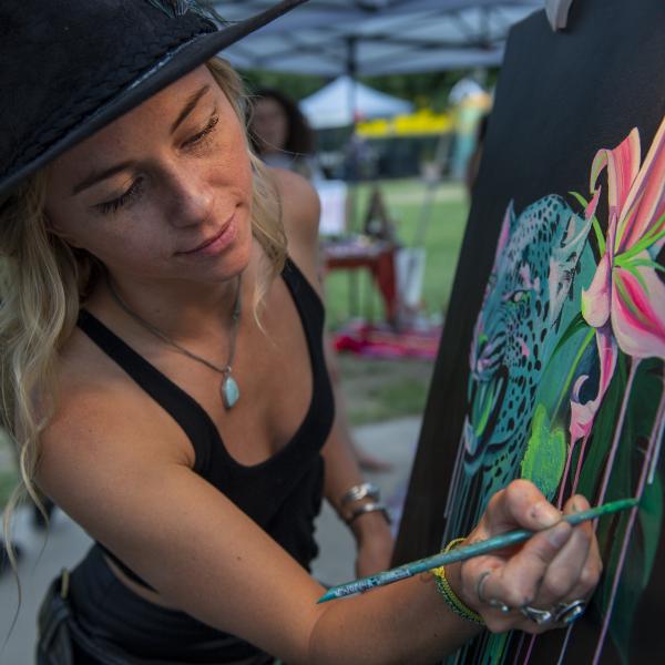 Kaila painting in a park