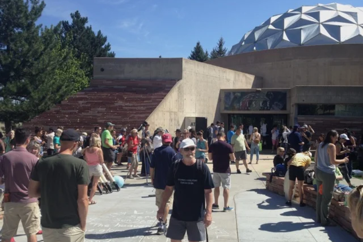 Exterior phot of Fiske entrance on a sunny day with lots of people