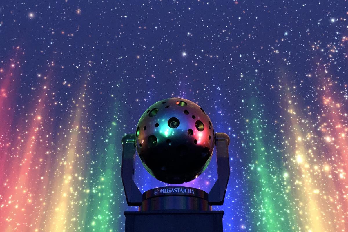 Megastar projector in theater with rainbow pillars of lights