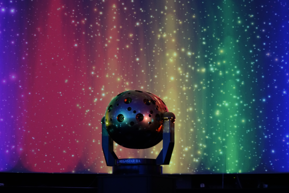 Megastar projector in theater with rainbow pillars of lights