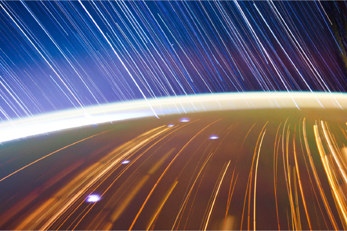Image of the earth limb from space with star trails
