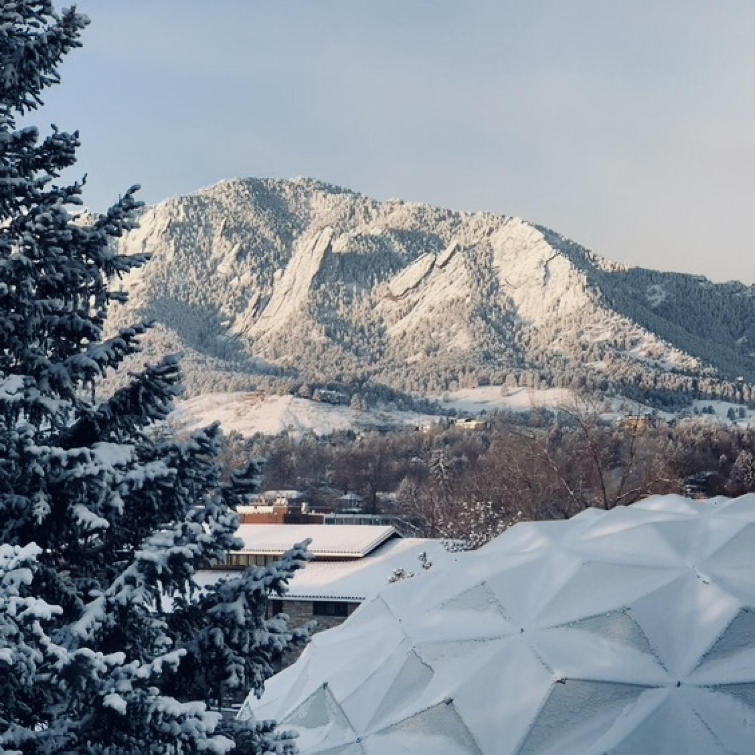 Photo looking at the Flatirons in the snow with Fiske dome in view to the lower right