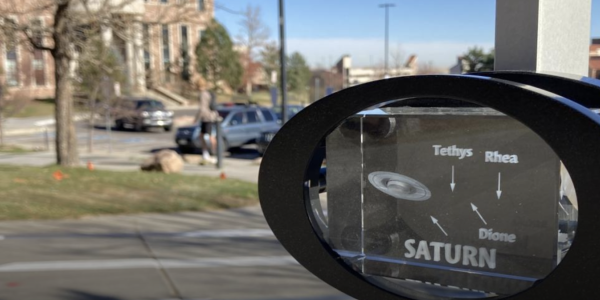 A glass block marks Saturn's spot in the solar system in a new scale model on the CU Boulder campus. 