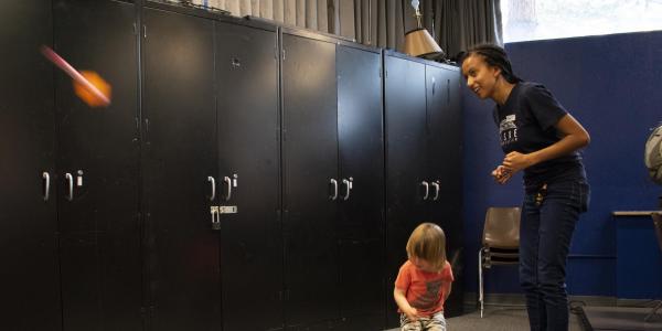 Teacher showing young child how to launch a stomp rocket