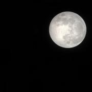Photo of a full Moon against a dark black sky