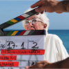 picture of old woman being filmed with large camera