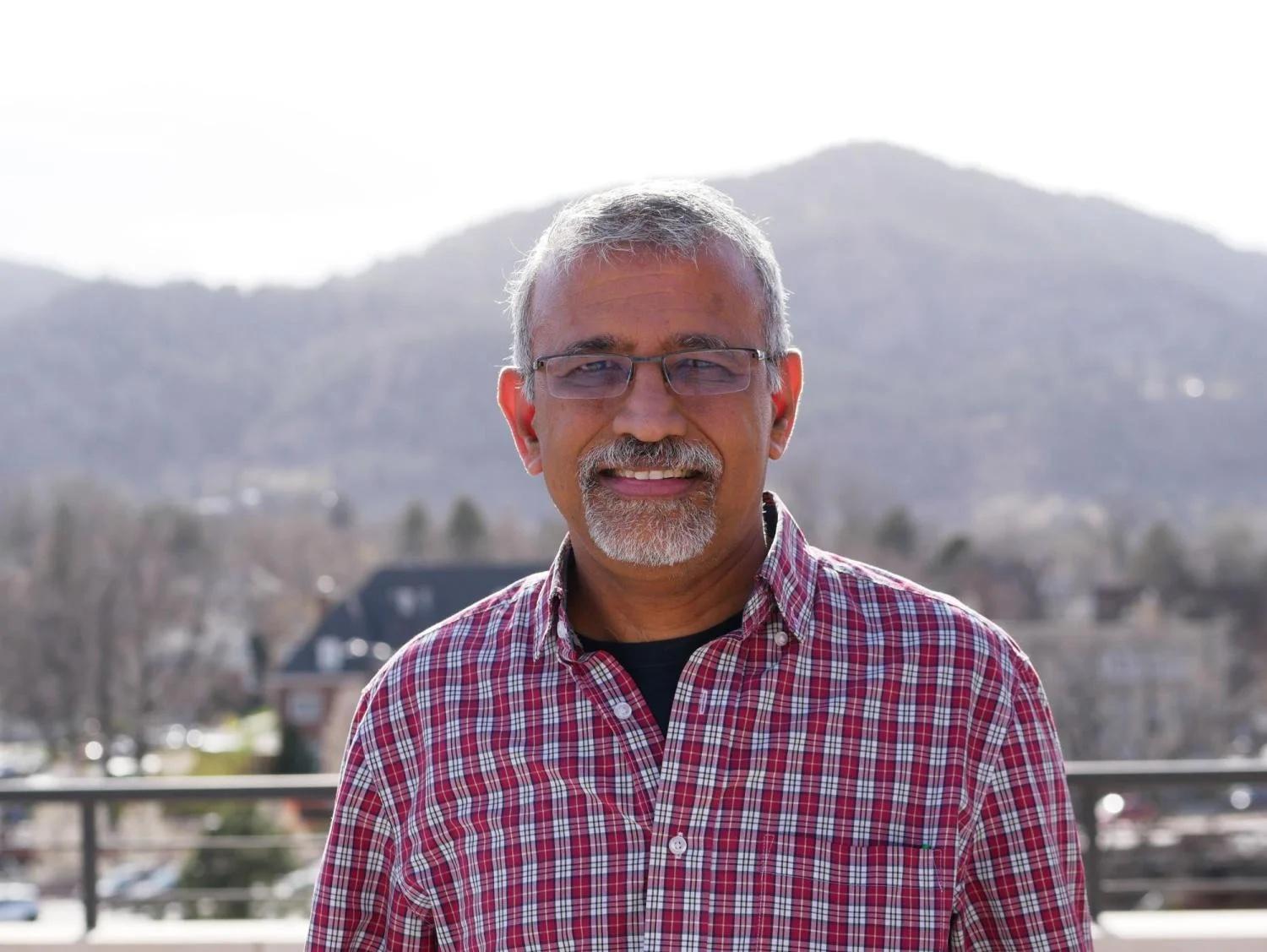 Balaji in a button-down shirt with mountains in the background