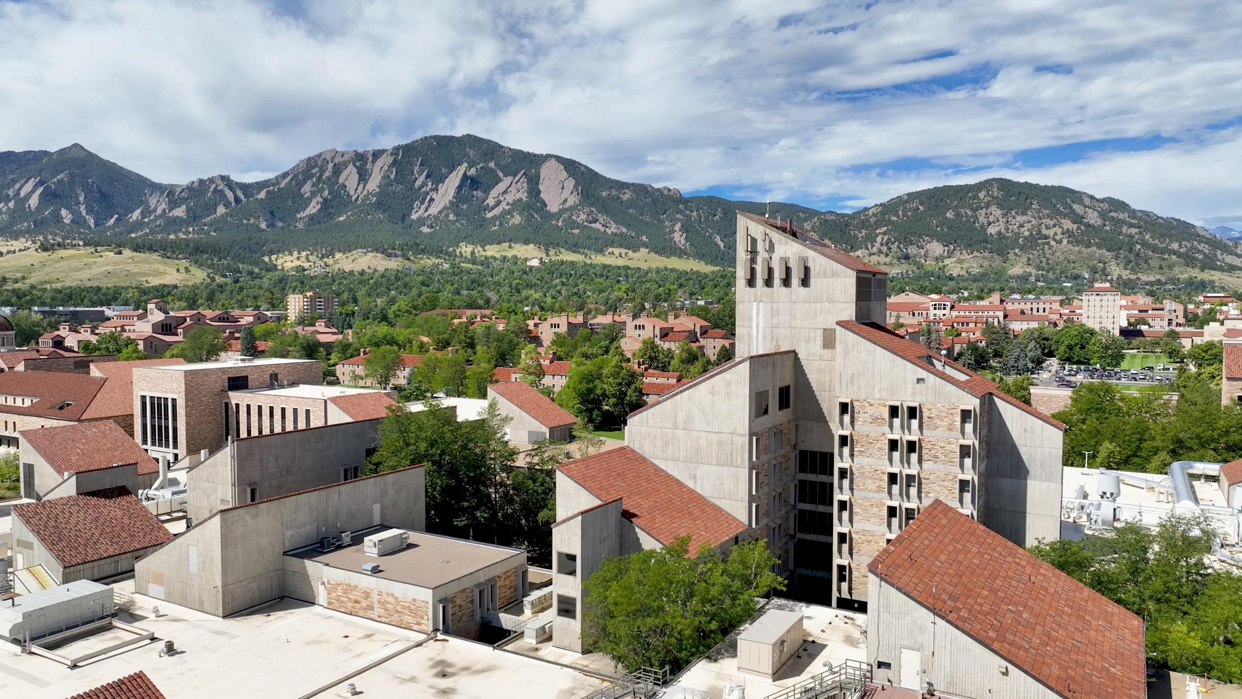 Campus aerial with engineering building and Flatirons in the background