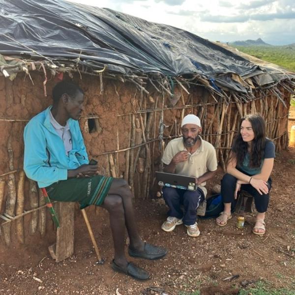 Posner and her Research Assistant, Noor Hussein Noor, piloting the questionnaire with a Samburu pastoralist at his manyatta (homestead) March 2025.