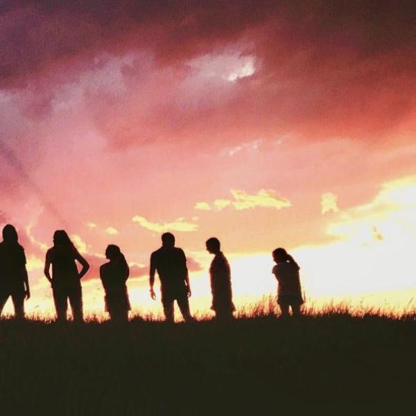 Silhouette of students standing on the horizon