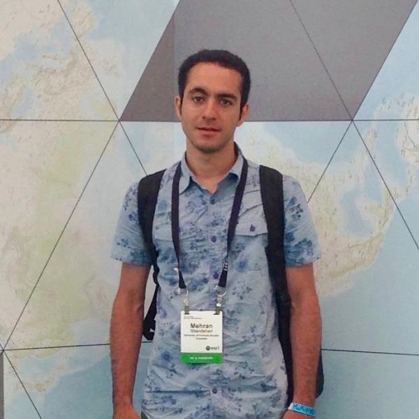 Man standing in front of graphics for ESRI event