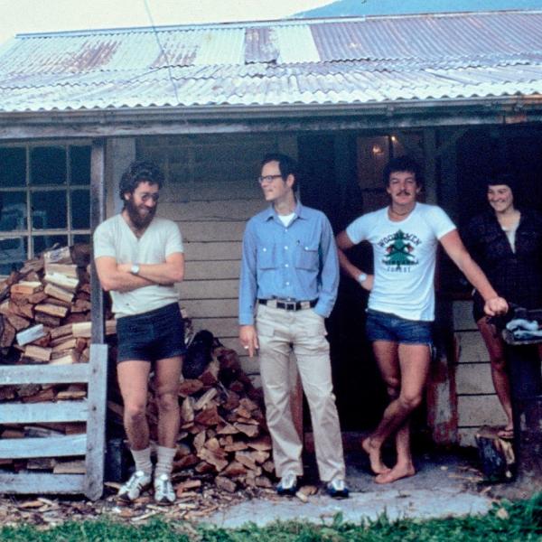 Group standing on front porch of old house in New Zealand