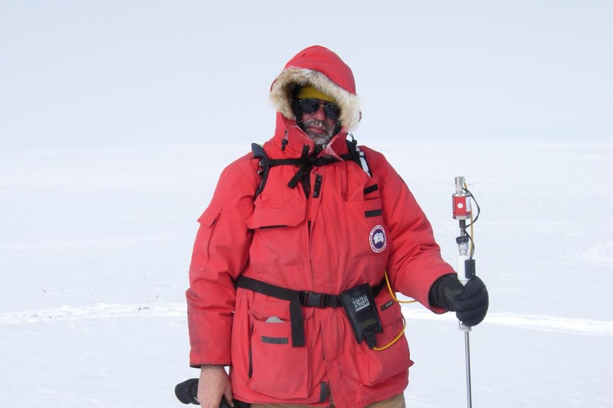 Man in red parka standing in snow