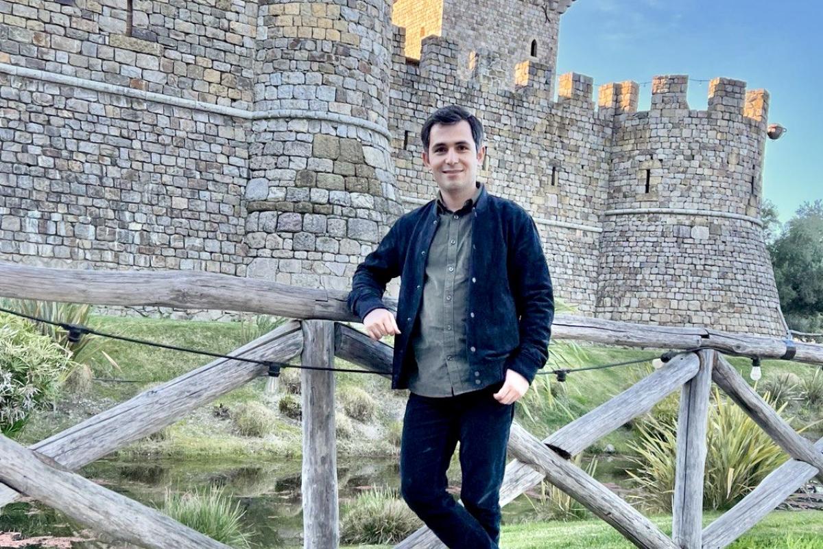 Behzad Vahedi standing in front of stone castle