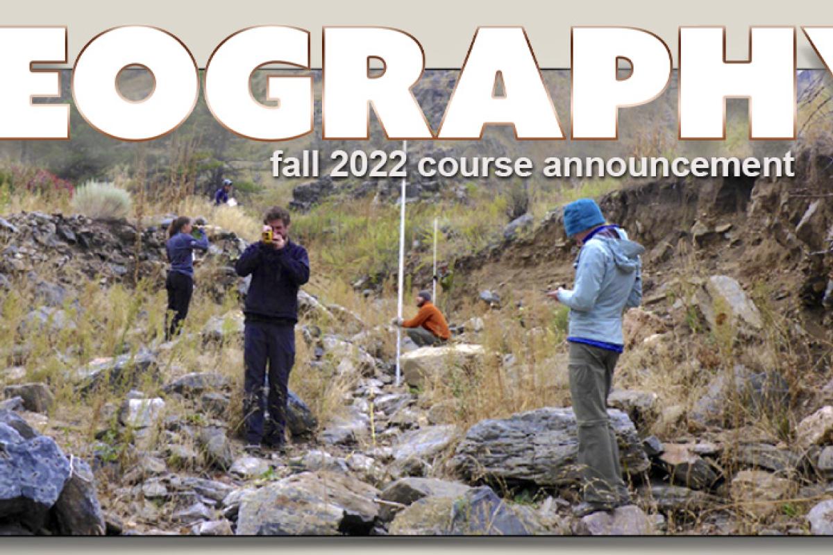 People taking measurements in dry creek bed