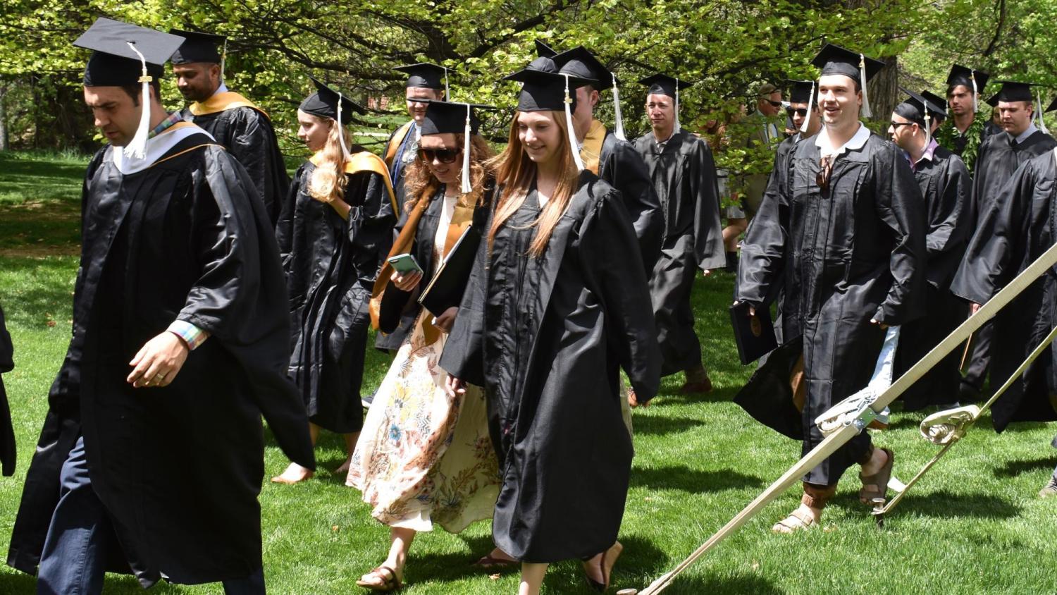 Students walking in graduation gowns