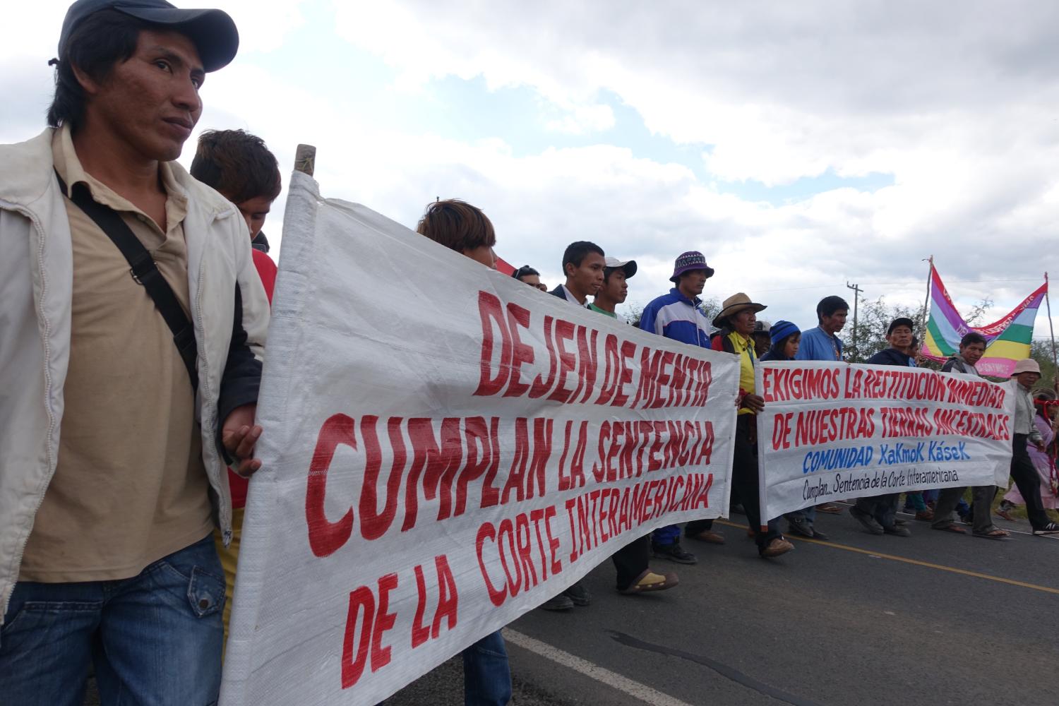 Protesters marching in the street, holding banners