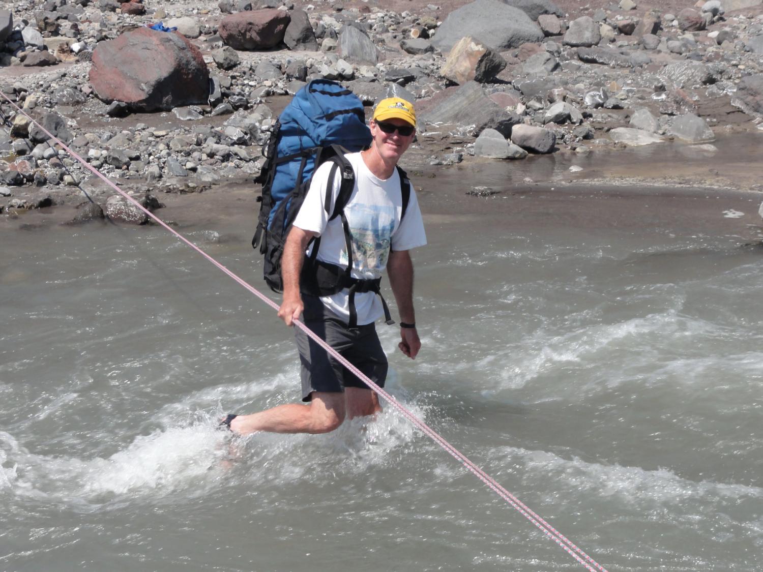 Faculty member John Pitlick crossing the North Fork of the Toutle River near Mount St. Helens, WA. August 2010