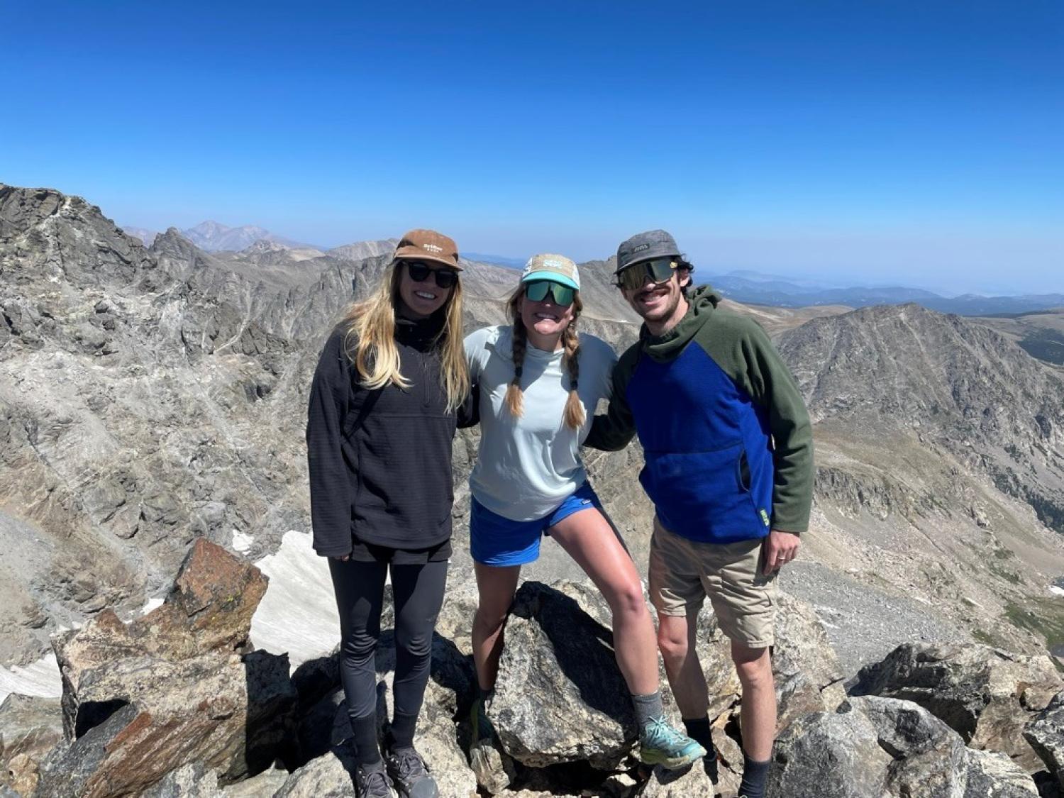 Spencer (center) with fellow Geography PhD student Sydney Carr (left) after conducting drone flights over Arapaho glacier last summer.