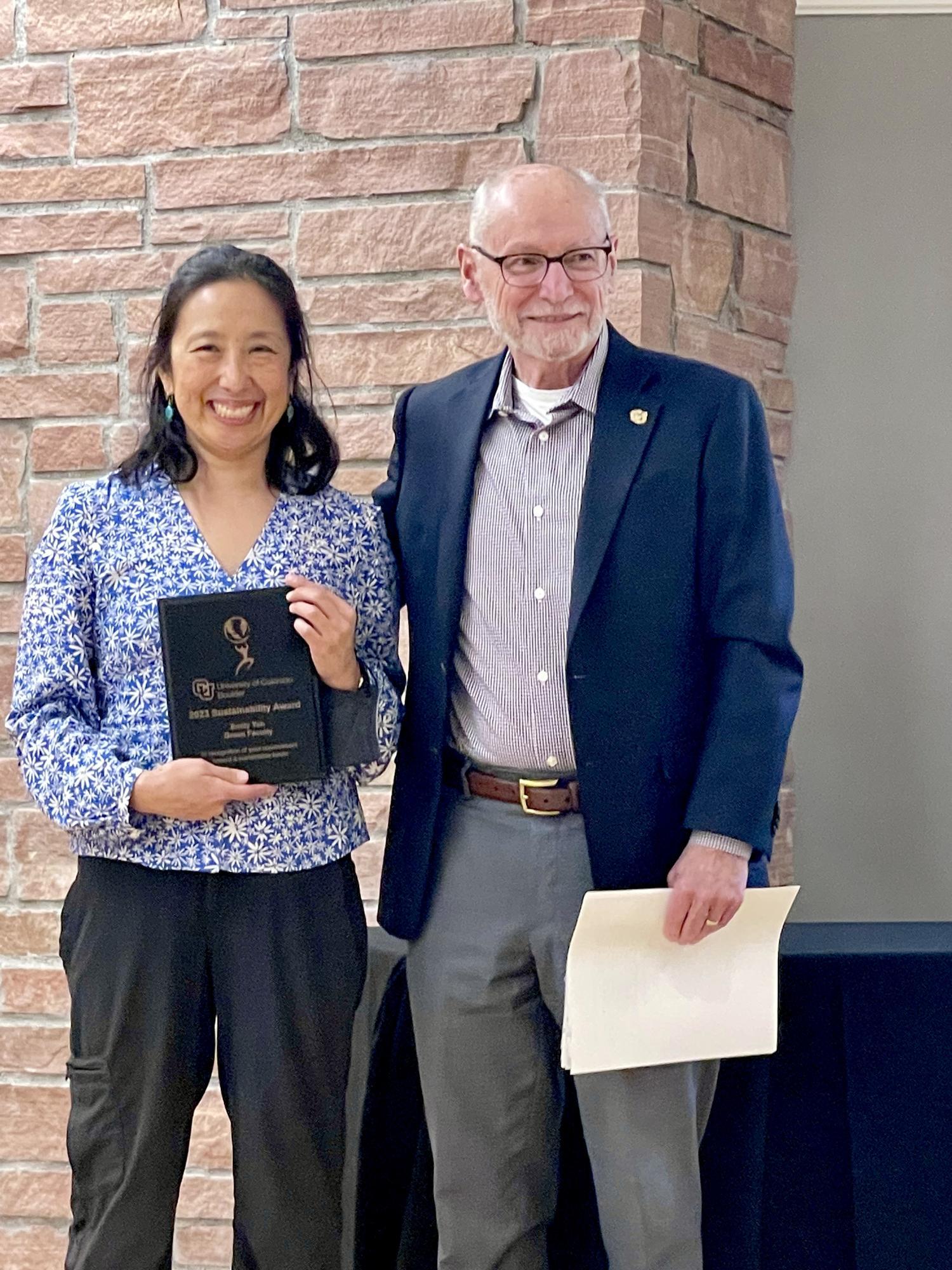 Man with woman holding award