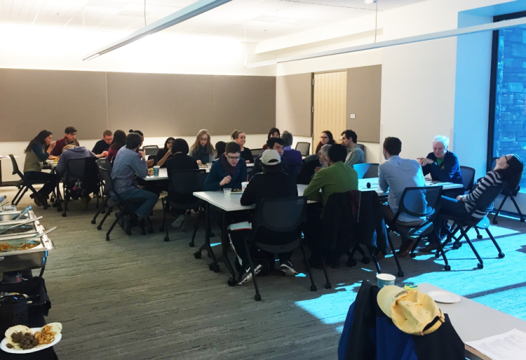 Groups of people sitting in room at tables