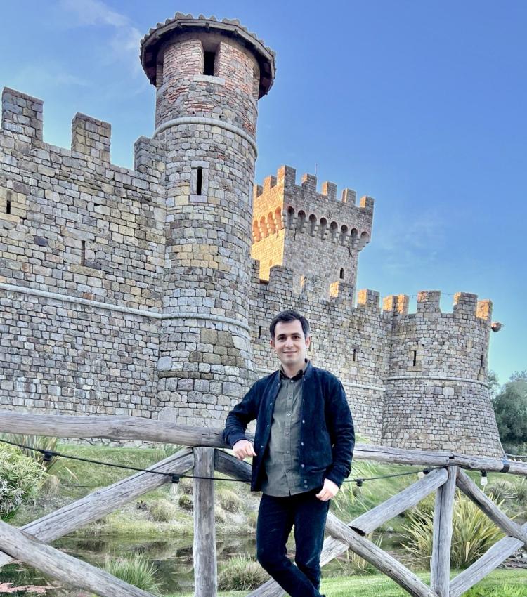 Behzad Vahedi standing in front of stone castle