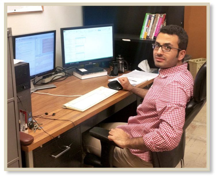 Hamid sitting at his desk