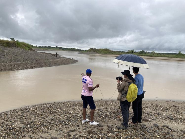 3 people looking at flooding