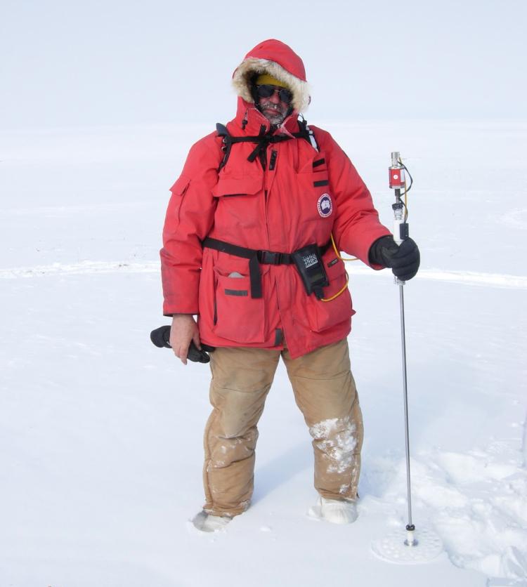Man in red parka standing in snow