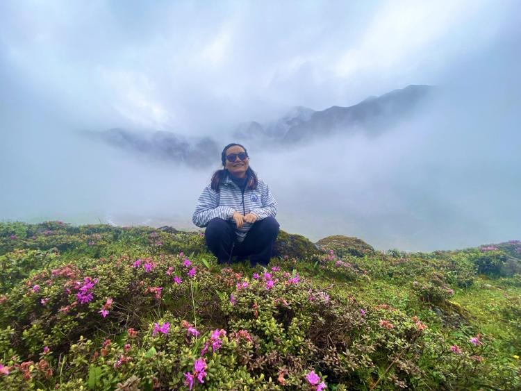 Woman on mountain with flowers