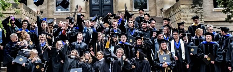 Commencement group photo of student tossing their mortarboards