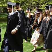 Students walking in graduation gowns