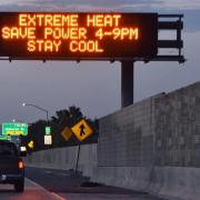 Cars driving under sign