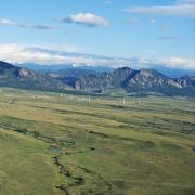 Aerial shot of Rocky Flats with mountain backdrop