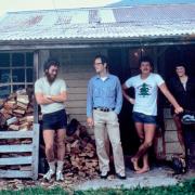 Group standing on front porch of old house in New Zealand